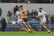 19 February 2023; Jamie Malone of Clare in action against Eoin Doyle, left, and Ryan Houlihan of Kildare during the Allianz Football League Division Two match between Clare and Kildare at Cusack Park in Ennis, Clare. Photo by Seb Daly/Sportsfile