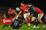 17 February 2023; Malakai Fekitoa of Munster offloads to teammate Antoine Frisch during the United Rugby Championship match between Munster and Ospreys at Thomond Park in Limerick. Photo by Harry Murphy/Sportsfile