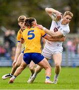 19 February 2023; Daniel Flynn of Kildare in action against Cian O’Dea of Clare, 5, during the Allianz Football League Division Two match between Clare and Kildare at Cusack Park in Ennis, Clare. Photo by Seb Daly/Sportsfile