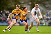 19 February 2023; Daniel Flynn of Kildare in action against Cian O’Dea, centre, and Brendan Rouine of Clare during the Allianz Football League Division Two match between Clare and Kildare at Cusack Park in Ennis, Clare. Photo by Seb Daly/Sportsfile