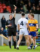 19 February 2023; Referee David Murnane shows a yellow card to Ryan Houlihan of Kildare, 4, during the Allianz Football League Division Two match between Clare and Kildare at Cusack Park in Ennis, Clare. Photo by Seb Daly/Sportsfile