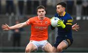 19 February 2023; Jarly Og Burns of Armagh and Roscommon goalkeeper Conor Carroll during the Allianz Football League Division One match between Roscommon and Armagh at Dr Hyde Park in Roscommon. Photo by Harry Murphy/Sportsfile