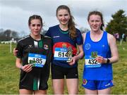 22 February 2023; Winner of the intermediate girls event Clodagh Gill of St Mary's Ballina in Mayo, centre, with Sarah Hartnett of Dunmore Community School in Galway, left, who finished second, and Molly Smith of SCC Carraroe in Galway, who finished third, during the 123.ie Connacht Schools’ Cross Country Championships at Bushfield in Loughrea, Galway. Photo by Piaras Ó Mídheach/Sportsfile