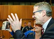 17 February 2023; Jarlath Burns stands with his sister Bronwyn Traynor as he blows kisses to his mother Helen Burns and sister Helena Burns on FaceTime after he was voted-in as the GAA president elect during day one of the GAA Annual Congress 2023 at Croke Park in Dublin. Photo by Piaras Ó Mídheach/Sportsfile