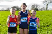24 February 2023; Faye Mannion, centre, from Colaiste Muire, Ennis, Co Clare after winning the Junior Girls race from second place Rachel O'Flynn, left, from Loreto Fermoy, Co Cork and third place Tianna O'Leary from Ursuline Convent, Thurles during the 123.ie Munster Schools Cross Country Championships at SETU Waterford in Waterford. Photo by Matt Browne/Sportsfile