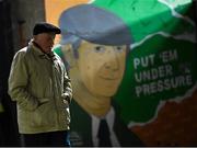 24 February 2023; A supporter walks past a mural of the late Republic of Ireland manager Jack Charlton on his arrival for the SSE Airtricity Men's Premier Division match between Bohemians and Dundalk at Dalymount Park in Dublin. Photo by Stephen McCarthy/Sportsfile