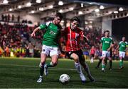 24 February 2023; Barry Coffey of Cork City in action against Ollie O'Neill of Derry City during the SSE Airtricity Men's Premier Division match between Derry City and Cork City at The Ryan McBride Brandywell Stadium in Derry. Photo by Ben McShane/Sportsfile