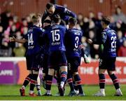 24 February 2023; Eoin Doyle of St Patrick's Athletick, hidden, celebrates with teammates after scoring his side's first goal during the SSE Airtricity Men's Premier Division match between St Patrick's Athletic and Shelbourne at Richmond Park in Dublin. Photo by Tyler Miller/Sportsfile
