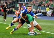 25 February 2023; Bundee Aki of Ireland dives over to score his side's third try despite the tackle of Stephen Varney of Italy during the Guinness Six Nations Rugby Championship match between Italy and Ireland at the Stadio Olimpico in Rome, Italy. Photo by Seb Daly/Sportsfile