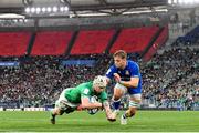 25 February 2023; Mack Hansen of Ireland dives over to score his side's fourth try despite the tackle by Lorenzo Cannone of Italy during the Guinness Six Nations Rugby Championship match between Italy and Ireland at the Stadio Olimpico in Rome, Italy. Photo by Ramsey Cardy/Sportsfile
