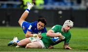 25 February 2023; Mack Hansen of Ireland dives over the line to score his side's fifth try despite the tackle of Ange Capuozzo of Italy during the Guinness Six Nations Rugby Championship match between Italy and Ireland at the Stadio Olimpico in Rome, Italy. Photo by Ramsey Cardy/Sportsfile