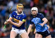 25 February 2023; Mark Kehoe of Tipperary scores a point under pressure from Conor Donohoe of Dublin during the Allianz Hurling League Division 1 Group B match between Dublin and Tipperary at Croke Park in Dublin. Photo by Piaras Ó Mídheach/Sportsfile