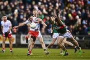 25 February 2023; Darragh Canavan of Tyrone kicks a point despite the attention of Sam Callinan of Mayo during the Allianz Football League Division 1 match between Mayo and Tyrone at Hastings Insurance MacHale Park in Castlebar, Mayo. Photo by Ben McShane/Sportsfile