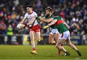 25 February 2023; Joe Oguz of Tyrone in action against Aidan O'Shea, centre, and Stephen Coen of Mayo during the Allianz Football League Division 1 match between Mayo and Tyrone at Hastings Insurance MacHale Park in Castlebar, Mayo. Photo by Ben McShane/Sportsfile