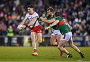 25 February 2023; Joe Oguz of Tyrone in action against Aidan O'Shea, centre, and Stephen Coen of Mayo during the Allianz Football League Division 1 match between Mayo and Tyrone at Hastings Insurance MacHale Park in Castlebar, Mayo. Photo by Ben McShane/Sportsfile