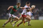25 February 2023; Joe Oguz of Tyrone in action against David McBrien of Mayo during the Allianz Football League Division 1 match between Mayo and Tyrone at Hastings Insurance MacHale Park in Castlebar, Mayo. Photo by Ben McShane/Sportsfile