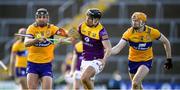 26 February 2023; Jack O'Connor of Wexford is tackled by Clare players, Cathal Malone, left, and David Fitzgerald during the Allianz Hurling League Division 1 Group A match between Wexford and Clare at Chadwicks Wexford Park in Wexford. Photo by Ray McManus/Sportsfile