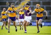 26 February 2023; Jack O'Connor of Wexford is tackled by Clare players, Cathal Malone, left, and David Fitzgerald during the Allianz Hurling League Division 1 Group A match between Wexford and Clare at Chadwicks Wexford Park in Wexford. Photo by Ray McManus/Sportsfile