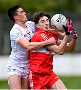 26 February 2023; Paul Cassidy of Derry is tackled by Mick O'Grady of Kildare during the Allianz Football League Division 2 match between Kildare and Derry at St Conleth's Park in Newbridge, Kildare. Photo by Piaras Ó Mídheach/Sportsfile