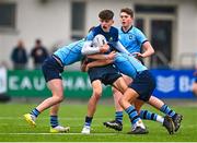 28 February 2023; Cory O'Connor of Castleknock College is tackled by Haydn Gallagher, left, and Scott Barron of St Michael's College during the Bank of Ireland Leinster Schools Junior Cup Quarter Final match between Castleknock College and St Michael’s College at Energia Park in Dublin. Photo by Ben McShane/Sportsfile