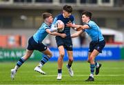28 February 2023; Cory O'Connor of Castleknock College is tackled by Matthew Haugh, left, and Scott Barron of St Michael's College during the Bank of Ireland Leinster Schools Junior Cup Quarter Final match between Castleknock College and St Michael’s College at Energia Park in Dublin. Photo by Ben McShane/Sportsfile