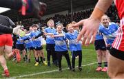 26 February 2023; Children from Allenwood GAA, including Kate Moran, 9, Ruby Lenehan, 11, Ruby Ann Roux, 18, Joe Cross, 7, and Daire Fayne, 15, welcome the teams to the pitch before the Allianz Football League Division 2 match between Kildare and Derry at St Conleth's Park in Newbridge, Kildare. Photo by Piaras Ó Mídheach/Sportsfile