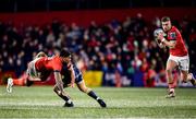 3 March 2023; Malakai Fekitoa of Munster offloads to teammate Shane Daly while being tackled by Sam Costelow of Scarlets during the United Rugby Championship match between Munster and Scarlets at Musgrave Park in Cork. Photo by Tom Beary/Sportsfile