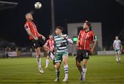 3 March 2023; Mark Connolly of Derry City heads the ball away during the closing stages of the SSE Airtricity Men's Premier Division match between Shamrock Rovers and Derry City at Tallaght Stadium in Dublin, ahead of Simon Power of Shamrock Rovers. Photo by Stephen McCarthy/Sportsfile