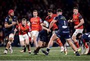 3 March 2023; Antoine Frisch of Munster is tackled by Shaun Evans, left, and Kemsley Mathias of Scarlets during the United Rugby Championship match between Munster and Scarlets at Musgrave Park in Cork. Photo by Tom Beary/Sportsfile