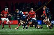 3 March 2023; RG Snyman of Munster is tackled by Sam Costelow of Scarlets, left, and Sione Kalamafoni during the United Rugby Championship match between Munster and Scarlets at Musgrave Park in Cork. Photo by Tom Beary/Sportsfile