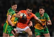 4 March 2023; Greg McCabe of Armagh is tackled by Conor O'Donnell, left, and Dáire Ó Baoill of Donegal during the Allianz Football League Division 1 match between Armagh and Donegal at Box-It Athletic Grounds in Armagh. Photo by Piaras Ó Mídheach/Sportsfile