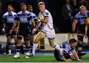 4 March 2023; Nathan Doak of Ulster on his way to scoring a try despite the efforts of Rhys Carré of Cardiff during the United Rugby Championship match between Cardiff and Ulster at Cardiff Arms Park in Cardiff, Wales. Photo by Andrew Orchard/Sportsfile
