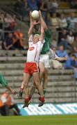 6 June 2004; Owen Mulligan,Tyrone, contests a high ball with Martin McGrath, Fermanagh. Bank of Ireland Ulster Senior Football Championship, Tyrone v Fermanagh, St. Tighernach's Park, Clones, Co. Monaghan. Picture credit; Damien Eagers / SPORTSFILE