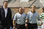 12 June 2004; Referee Alan Kelly, right, and his linesman are escorted from the field after the game by security officer Derek McGuinness. eircom league, Premier Division, Shamrock Rovers v Bohemians, Dalymount Park, Dublin. Picture credit; Pat Murphy / SPORTSFILE