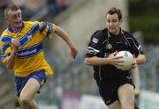 12 June 2004; Michael Langan, Sligo, in action against Denis Russell, Clare. Bank of Ireland Football Championship Qualifier, Round 1, Clare v Sligo, Cusack Park, Ennis, Co. Clare. Picture credit; SPORTSFILE