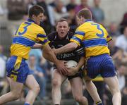 12 June 2004; Dessie Sloyan, Sligo, is tackled by Enda Coughlan and Conor Whelan, Clare. Bank of Ireland Football Championship Qualifier, Round 1, Clare v Sligo, Cusack Park, Ennis, Co. Clare. Picture credit; SPORTSFILE