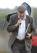 12 June 2004; Peter Keogh, president of the Wicklow County board, walks off the pitch at the end of the game holding his chair. Bank of Ireland Football Championship Qualifier, Round 1, Wicklow v Derry, County Grounds, Aughrim, Co. Wicklow. Picture credit; David Maher / SPORTSFILE