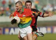 12 June 2004; Johnny Kavanagh, Carlow, in action against Ronan Murtagh, Down. Bank of Ireland Football Championship Qualifier, Round 1, Carlow v Down, Dr. Cullen Park, Carlow. Picture credit; Damien Eagers / SPORTSFILE