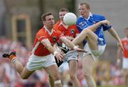 13 June 2004; Jason O'Reilly, Cavan, has his shot blocked down by Enda McNulty, left, Armagh, supported by team-mate John Toal. Bank of Ireland Ulster Senior Football Championship Semi-Final, Cavan v Armagh, St. Tighernach's Park, Clones, Co. Monaghan. Picture credit; Damien Eagers / SPORTSFILE