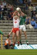 6 June 2004; Owen Mulligan, Tyrone, goes up for a high ball with Martin McGrath, Fermanagh. Bank of Ireland Ulster Senior Football Championship, Tyrone v Fermanagh, St. Tighernach's Park, Clones, Co. Monaghan. Picture credit; Damien Eagers / SPORTSFILE