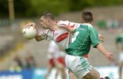 6 June 2004; Sean Cavanagh, Tyrone, is tackled by Hugh Brady, Fermanagh. Bank of Ireland Ulster Senior Football Championship, Tyrone v Fermanagh, St. Tighernach's Park, Clones, Co. Monaghan. Picture credit; Damien Eagers / SPORTSFILE