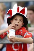 13 June 2004; A young Cork fan enjoys a packet of crisps during the game. Munster Junior Football Championship Semi-Final, Kerry v Cork, Fitzgerald Stadium, Killarney, Co. Kerry. Picture credit; Brendan Moran / SPORTSFILE