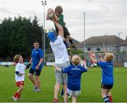 23 August 2013; Leinster's Jamie Heaslip lifts Jack O'Neill, age 8, from Fairview, Dublin, during a Leinster Rugby Summer Camp at Clontarf RFC, Clontarf, Co. Dublin. Picture credit: Brian Lawless / SPORTSFILE