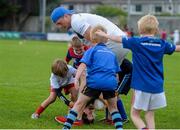 23 August 2013; Leinster's Jamie Heaslip tackles Jack O'Neill, age 8, from Fairview, Dublin, during a Leinster Rugby Summer Camp at Clontarf RFC, Clontarf, Co. Dublin. Picture credit: Brian Lawless / SPORTSFILE