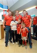 23 August 2013; To celebrate the return of Bank of Ireland as main sponsor of Munster Rugby, players David Kilcoyne, Tommy O’Donnell and Luke O’Dea surprised customers and staff by turning up to work in Nenagh branch today. With the players are, from left to right, brothers Kevin, aged 11, Cormac, aged 8 and Donal Cleary, aged 4, all from Borrisokane, Co. Tipperary, with Bank of Ireland, Nenagh, Co. Tipperary. Picture credit: Diarmuid Greene / SPORTSFILE