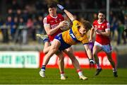 5 March 2023; Rory Maguire of Cork avoids the tackle of Dermot Coughlan of Clare during the Allianz Football League Division 2 match between Clare and Cork at Cusack Park in Ennis, Clare. Photo by Eóin Noonan/Sportsfile