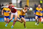 5 March 2023; Manus Doherty of Clare is tackled by Conor Corbett of Cork during the Allianz Football League Division 2 match between Clare and Cork at Cusack Park in Ennis, Clare. Photo by John Sheridan/Sportsfile