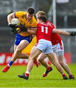 5 March 2023; Jamie Moore of Clare is tackled by Sean Powter of Cork during the Allianz Football League Division 2 match between Clare and Cork at Cusack Park in Ennis, Clare. Photo by Eóin Noonan/Sportsfile
