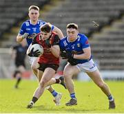 5 March 2023; Andrew Gilmore of Down in action against Niall Carolan of Cavan during the Allianz Football League Division 3 match between Cavan and Down at Kingspan Breffni in Cavan. Photo by Stephen Marken/Sportsfile