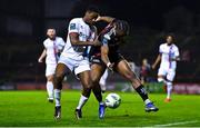 6 March 2023; Jonathan Afolabi of Bohemians in action against Emmanuel Adegboyega of Drogheda United during the SSE Airtricity Men's Premier Division match between Bohemians and Drogheda United at Dalymount Park in Dublin. Photo by Harry Murphy/Sportsfile